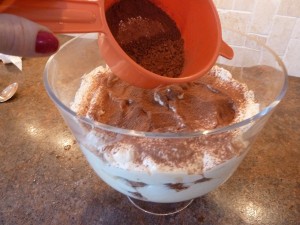 sifting cocoa powder on the tiramisu