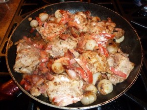 Coq au Vin - add the tomato, onions, bacon and herbs
